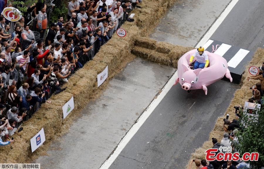 Competitors ride a homemade vehicle on a downhill track during the Red Bull Soapbox Race in Sao Paulo, Brazil, April 14, 2019. The Red Bull Soapbox race is an annual event where amateur drivers race their homemade soapbox vehicles down a hill through obstacles. (Photo/Agencies)