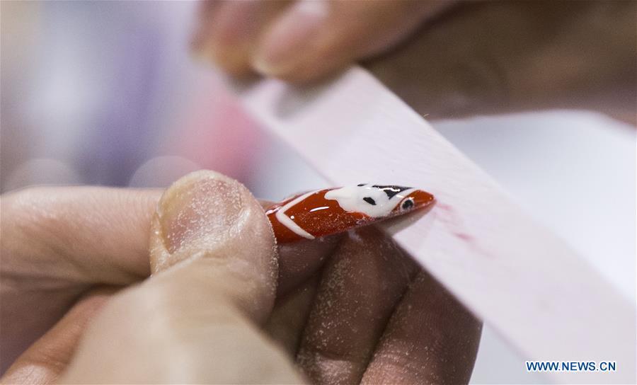 <?php echo strip_tags(addslashes(A competitor buffs a nail during the Nail Art Challenge at the 2019 Revel in Beauty event in Toronto, Canada, on April 15, 2019. The Nail Art Challenge was held on Monday to showcase the creative process of nail art to spectators. (Xinhua/Zou Zheng))) ?>