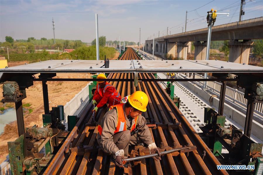 <?php echo strip_tags(addslashes(Builders of China Railway 12th Bureau Group work on the Liying section of the Beijing-Xiongan intercity railway, April 15, 2019. Track-laying work of the Beijing-Xiongan intercity railway began on Monday. (Xinhua/Xing Guangli))) ?>