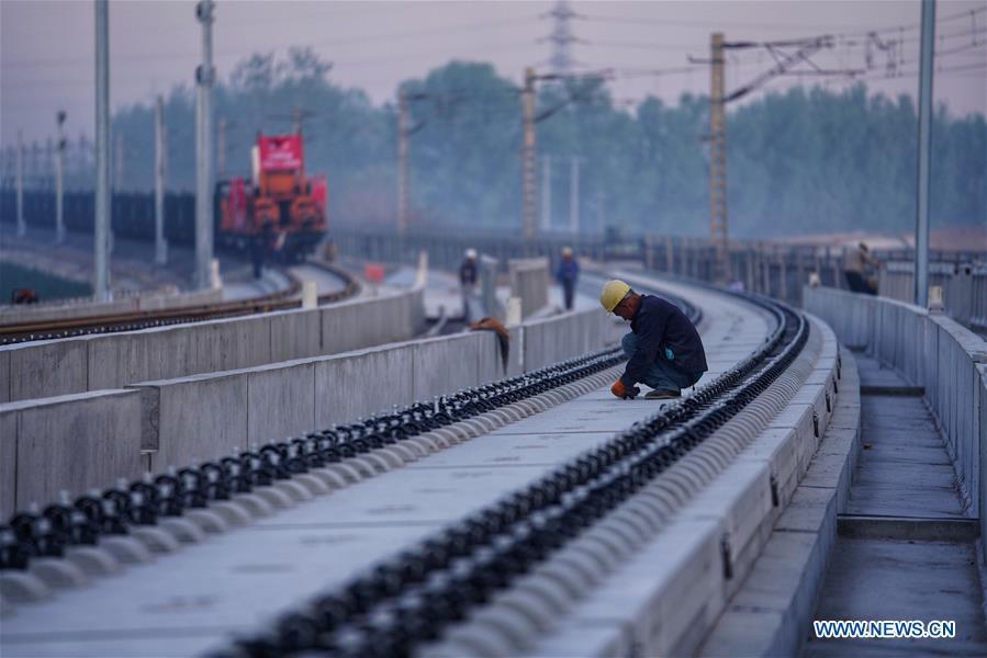 <?php echo strip_tags(addslashes(Builders of China Railway 12th Bureau Group work on the Liying section of the Beijing-Xiongan intercity railway, April 15, 2019. Track-laying work of the Beijing-Xiongan intercity railway began on Monday. (Xinhua/Xing Guangli))) ?>