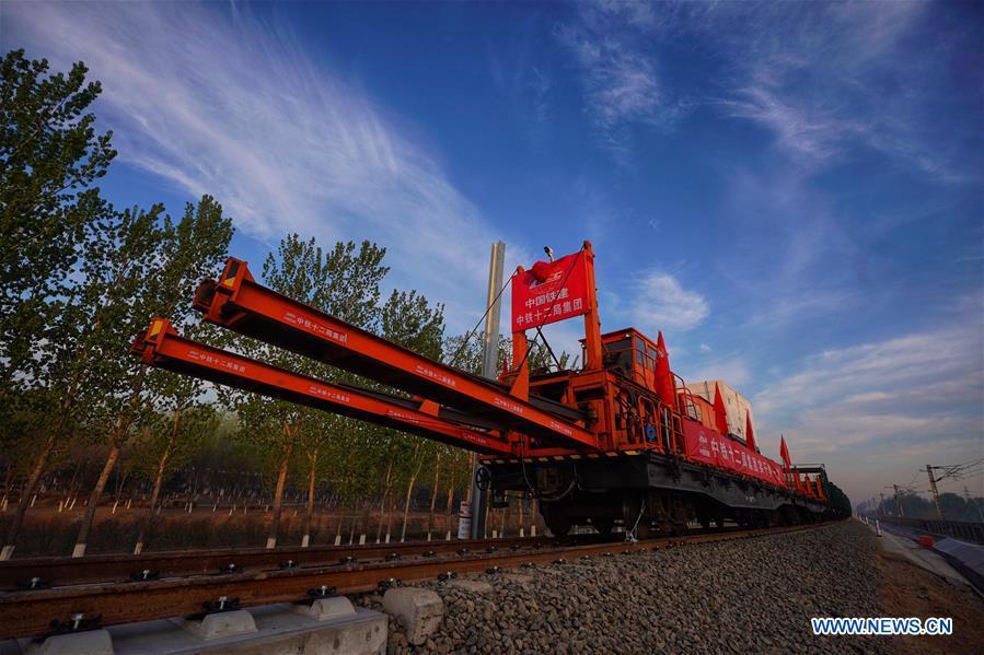 Builders of China Railway 12th Bureau Group operate machine to lay tracks at the construction site of the Liying section of the Beijing-Xiongan intercity railway, April 15, 2019. Track-laying work of the Beijing-Xiongan intercity railway began on Monday. (Xinhua/Xing Guangli)