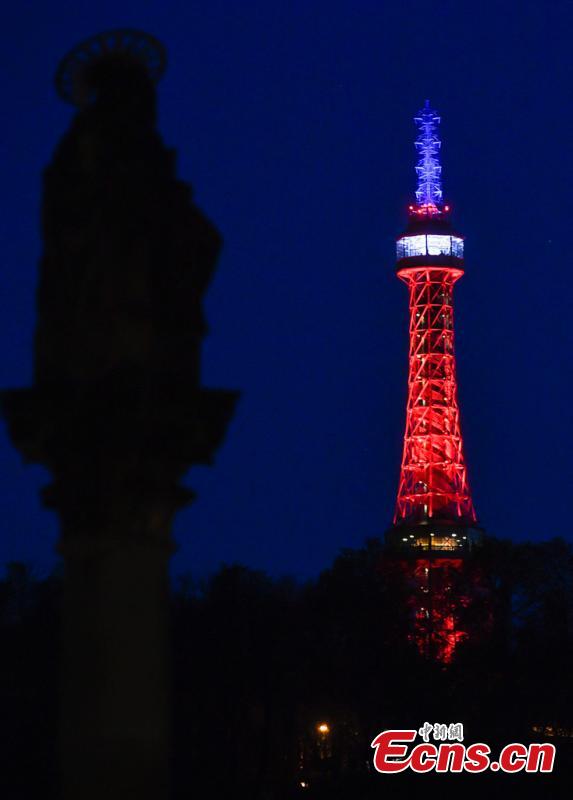 The Lookout Tower on Petrin Hill in Prague is lit up blue, white, and red on Tuesday, April 16, 2019 in solidarity with the people of France following the fire at the Notre Dame Cathedral.  (Photo/IC)