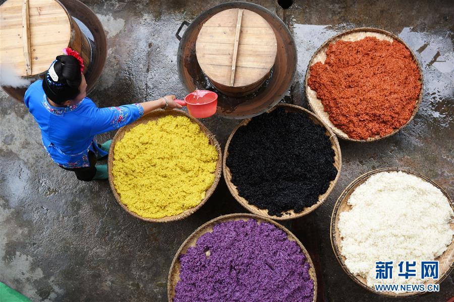 Women of Miao ethnic group made colorful sister rice to celebrate the Sister Meal Festival at Taijiang County, south China\'s Guizhou Province on April 17, 2019. (Photo/Xinhua)