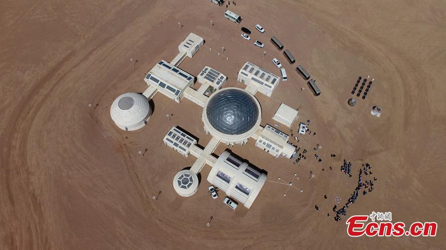 <?php echo strip_tags(addslashes(A picture taken with a drone shows an aerial view of the C-Space Project, a Mars simulation base in the Gobi Desert in Jinchang, Gansu Province, China, 16 April 2019. The C-Space Project Mars Base opened officially on 17 April 2019 with the aim to educate and provide an environment for youths and tourists to experience life on planet Mars. The base occupying an area of 11,996 square feet is situated about 40 kilometers from the town of Jinchang in the Gobi Desert. The location is chosen to simulate the landscape and harsh conditions of living on Mars as much as possible.  (Photo/China News Service))) ?>