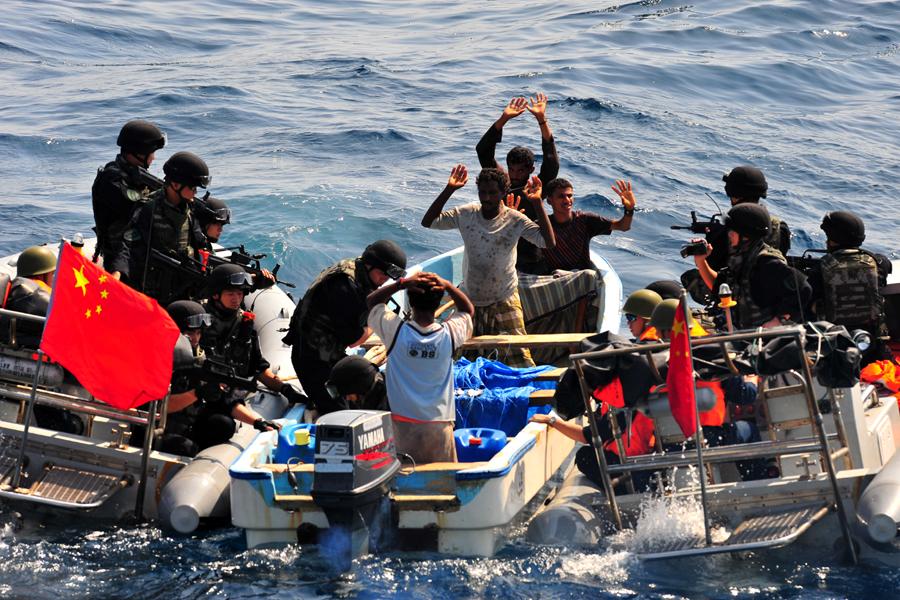 Members of a PLA Navy special forces team search a boat of suspected pirates in the Gulf of Aden. (CAO HAIHUA/FOR CHINA DAILY)