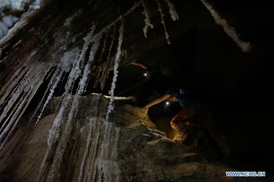 Cavers explore the Malham cave near the Dead Sea in southeastern Israel on April 14, 2019. Israeli and European researchers have discovered the world\'s deepest salt cave, Malham Cave with a depth of at least 10 kilometers, near the Dead Sea, said a report issued Thursday by the Hebrew University of Jerusalem. The researchers re-measured the 7,000-year-old Malham Cave, near the Dead Sea in southeastern Israel, and found that it is much longer than 5.5 kilometers as previously thought. Thus, the Israeli cave bypasses Iran\'s Cave of the Three Nudes (3N) on Qeshm Island, which since 2006 has been considered the world\'s deepest salt cave with a depth of 6.58 kilometers. (Xinhua/Gil Cohen Magen)