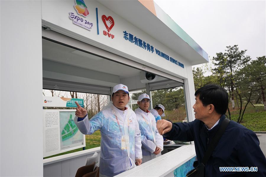 Volunteers give directions to a visitor to the site of the 2019 Beijing International Horticultural Exhibition (Expo 2019 Beijing) during a trial run in Yanqing District of Beijing, capital of China, April 20, 2019. Beijing on Saturday held a trial opening of the site for the upcoming 2019 Beijing International Horticultural Exhibition to test the reception capacity of the event. About 60,000 people visited the 503-hectare expo site Saturday. (Xinhua/Ju Huanzong)