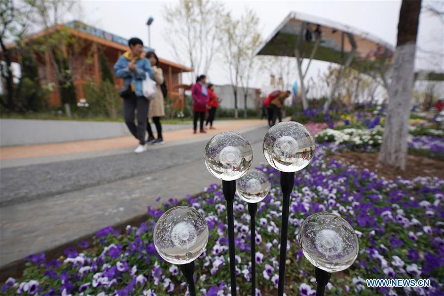 <?php echo strip_tags(addslashes(Visitors tour the site of the 2019 Beijing International Horticultural Exhibition (Expo 2019 Beijing) during a trial run in Yanqing District of Beijing, capital of China, April 20, 2019. Beijing on Saturday held a trial opening of the site for the upcoming 2019 Beijing International Horticultural Exhibition to test the reception capacity of the event. About 60,000 people visited the 503-hectare expo site Saturday. (Xinhua/Ju Huanzong))) ?>