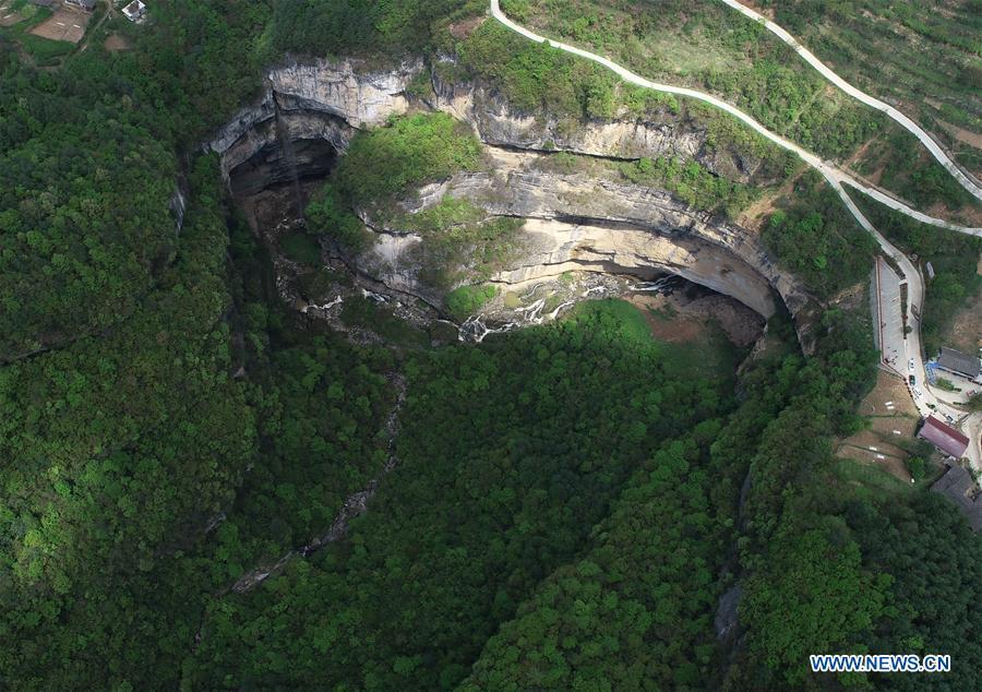 Aerial photo taken on April 22, 2019 shows the Didonghe Tiankeng, a giant karst sinkhole at Huoshizi Village of Ningqiang County in Hanzhong, northwest China\'s Shaanxi Province. With a maximum depth of 340 meters, the Didonghe Tiankeng is the largest in Chanjiayan Tiankeng Group in Ningqiang County. (Xinhua/Zhang Bowen)