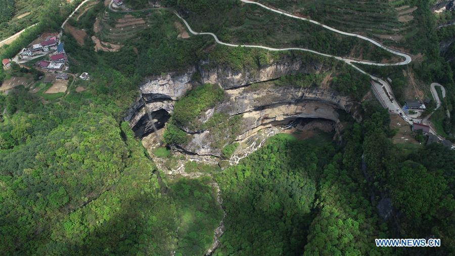 Aerial photo taken on April 22, 2019 shows the Didonghe Tiankeng, a giant karst sinkhole at Huoshizi Village of Ningqiang County in Hanzhong, northwest China\'s Shaanxi Province. With a maximum depth of 340 meters, the Didonghe Tiankeng is the largest in Chanjiayan Tiankeng Group in Ningqiang County. (Xinhua/Zhang Bowen)