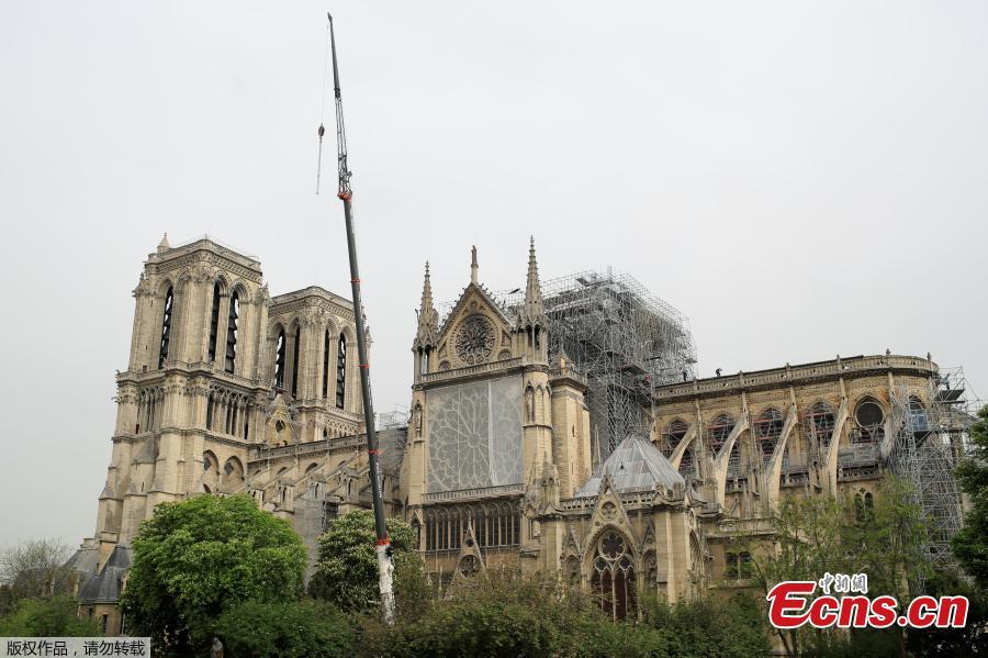 Protective material has been wrapped around parts of Notre Dame, April 23, 2019. Architects working on preserving Notre-Dame are rushing to cover the cathedral before rain can cause further damage. (Photo/Agencies)
