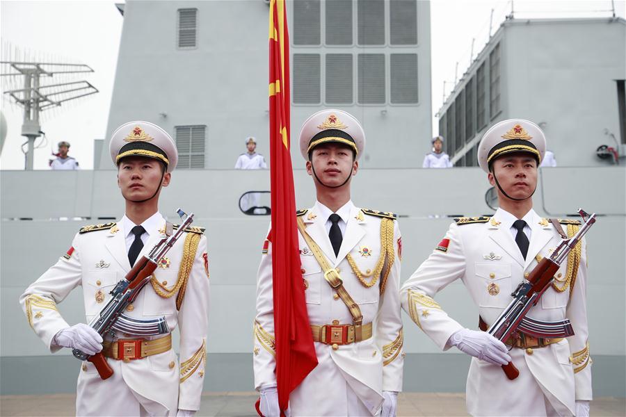 The honor guard of the Chinese People\'s Liberation Army (PLA) Navy stand in formation before a naval parade staged to mark the 70th founding anniversary of the PLA Navy at a pier in Qingdao, east China\'s Shandong Province, on April 23, 2019. (Xinhua/Li Gang)