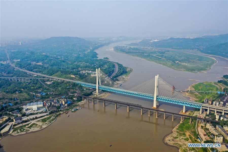 <?php echo strip_tags(addslashes(Aerial photo taken on April 23, 2019 shows the previous (Front) and the new Baishatuo Yangtze River railway bridge in Jiangjin of southwest China's Chongqing Municipality. The previous Baishatuo Yangtze River railway bridge, completed in 1959, will stop service after April 24. All trains will run on the new double decker steel truss cable stay railway bridge after that day. The new bridge has 4 tracks on the upper deck for passenger trains with a designed speed of 200 kilometers per hour and 2 tracks on the lower deck for cargo trains with the designed speed of 120 kilometers per hour. (Xinhua/Liu Chan))) ?>