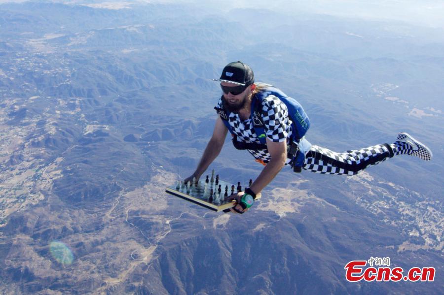Timur Faridovich Gareyev is pictured skydiving while holding a chess board. 31-year-old Timur is a chess player from Tashkent, Uzbekistan. He is also an experienced skydiver with 150 jumps under his belt. He jumped from the aircraft wearing a chequered jumpsuit with the chess pieces fixed onto the board on his way to contest a San Diego Chess Open in California. (Photo/IC)