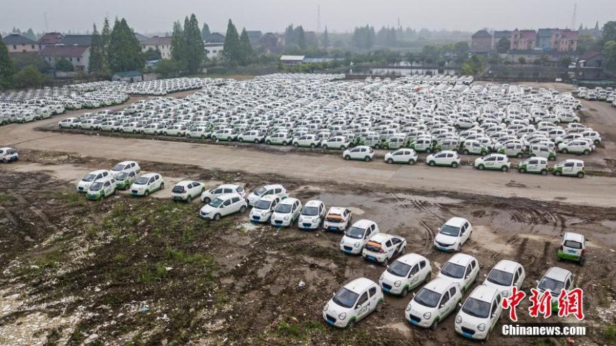 An aerial view of nearly 3000 new energy cars parked near the Qiantang River in Hangzhou City, East China\'s Zhejiang Province, April 24, 2019. The cars previously used in car sharing services have already become obsolete. (Photo: China News Service/Zhang Yang)