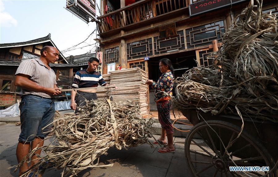 <?php echo strip_tags(addslashes(Wang Xingwu (C), a papermaker, weighs the raw material for papermaking in Shiqiao Village of Danzhai County, southwest China's Guizhou Province, April 24, 2019. Wang Xingwu, 53, a national intangible cultural heritage inheritor in papermaking, learned the papermaking technique from his family as a child. Besides exerting the old papermaking technique to its full potential, Wang keeps raising product quality and improving the making procedure. With the involvement of plants in the papermaking process, he has created more than 160 kinds of patterned papers and paper crafts. He also develops a kind of handmade white paper more suitable for writing calligraphy and painting. (Xinhua/Huang Xiaohai))) ?>