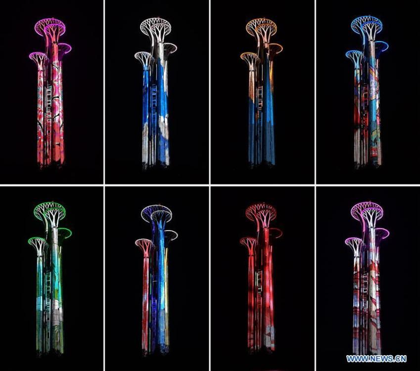 Combo photo shows the Olympic Tower is illuminated in Beijing, capital of China, April 26, 2019. Roads and buildings along the central axis were highlighted Friday evening for the Second Belt and Road Forum for International Cooperation in Beijing. (Xinhua/Li He)