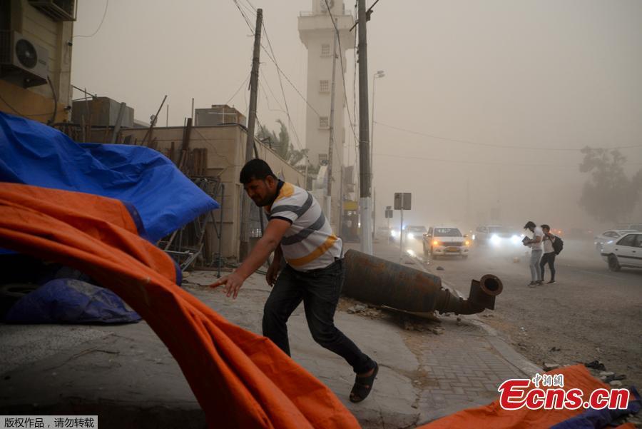 <?php echo strip_tags(addslashes(A man walks near a wind-toppled motorcycle in Iraq's central city of Najaf during a sand storm on, April 29, 2019. (Photo/Agencies))) ?>