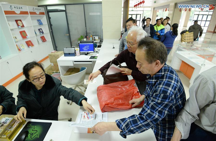 People purchase commemorative stamps for the 100 anniversary of the May 4th Movement at Handan branch office of China Post, in Handan City, north China\'s Hebei Province, May 4, 2019. China Post on Saturday issued a set of two commemorative stamps marking the 100 anniversary of the May Fourth Movement. (Xinhua/Hao Qunying)