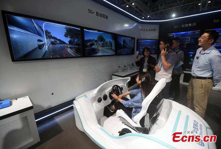 <?php echo strip_tags(addslashes(Visitors try out the self-driving experience in a booth by China Mobile at the second Digital China Summit in Fuzhou, Fujian Province, May 5, 2019. (Photo: China News Service/Zhang Bin))) ?>