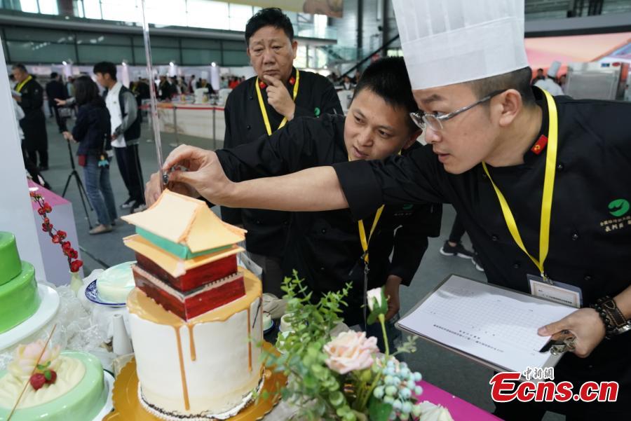 <?php echo strip_tags(addslashes(Participants compete in the 20th National Baking Skills Competition held at the Shanghai New International Expo Center, May 6, 2019. Eighty bakers from across the country took part in the competition organized by the China Association of Bakery and Confectionery Industry as well as other career guidance and industrial agencies. (Photo: China News Service/Wang Xin))) ?>