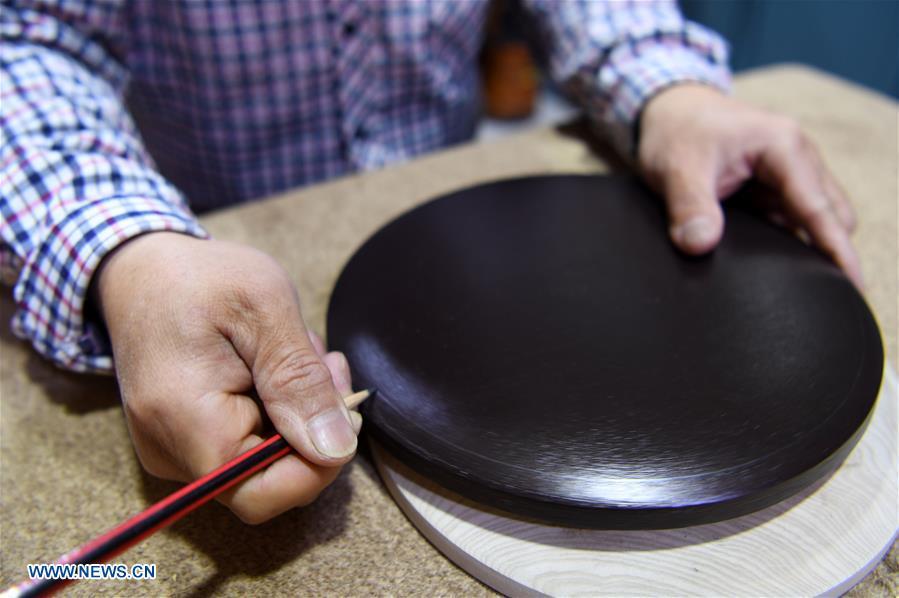 <?php echo strip_tags(addslashes(Shen Hongjie draws on wood at his workshop in Dunhuang, northwest China's Gansu Province, May 6, 2019. In 2004, Shen Hongjie was impressed by Dunhuang culture as he came here for sightseeing. He then left his hometown in central China's Hunan Province for Dunhuang. For 15 years, Shen Hongjie has been dedicated to promoting Dunhuang culture through woodcut. (Xinhua/Fan Peishen))) ?>