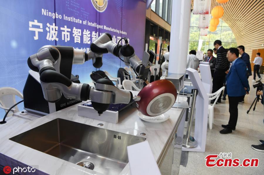 <?php echo strip_tags(addslashes(A robot performs tasks including writing calligraphy with a brush, cooking, and delivering beer after opening a bottle all on its own during the 6th China Robotop Summit in Ningbo City, East China's Zhejiang Province, May 9, 2019. According to its official website, the summit aims to promote the application of robots in intelligent manufacturing. (Photo/IC))) ?>