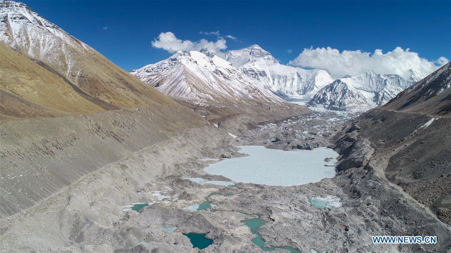 Aerial photo taken in southwest China\'s Tibet Autonomous Region on April 26, 2019 shows scenery of Mount Qomolangma. Every year, for a few weeks, hundreds of climbers and supporting personnel come to the base camp of the northern face of Mount Qomolangma, trying to reach the summit of the tallest and most famous mountain in the world. Before starting climbing, they need to hike several times between elevations from 5,000 meters to 7,000 meters, giving their bodies some time to adapt. When this process is over, it\'s all up to the weather. The base camp is a popular place to wait for the window. Among the six camps on the northern face, the base camp at an altitude of 5,200 meters is the furthest cars can reach and therefor the most equipped. Besides food and accommodation, climbers can also enjoy tea and massage. They can also play football on perhaps the highest field. There\'s even a simple gym in the camp. Environmental protection is a priority here. Garbage sacks are given to each climbing team. Special containers are put in every camp to collect trash and sewage. The collected trash must be treated 100 kilometers away, and the only road is a zigzagging track. It is not trucks, but yaks that are generally used to make the journey. Actually yaks are vital on the mountain. Beyond the base camp, yak is the only reliable transport. (Xinhua/Sun Fei)