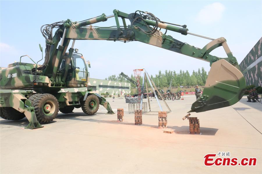 <?php echo strip_tags(addslashes(A unit of the People's Liberation Army Rocket Force held a skills contest where 100 military engineers competed to maneuver vehicles and machines including excavators, loaders, cranes, and forklifts passed various obstacles. (Photo: China News Service/Fang Lei))) ?>