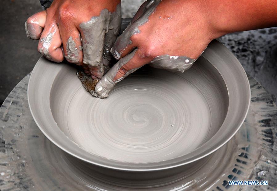 <?php echo strip_tags(addslashes(Wang Yaole, an apprentice of Wang Junzi, makes a Ru porcelain work in Qingliangsi Village, Baofeng County of central China's Henan Province, May 8, 2019. Ru porcelain, one of the five famous kinds of porcelains during the Song Dynasty (960-1279) in ancient China, is known for its azure color, light body, filmy grain and gentle textile. Wang Junzi, born in 1960, is a Ru porcelain firing craftsman in Qingliangsi Village of Baofeng County in central China's Henan, where the ancient official Ru porcelain kiln in Song Dynasty is located. In order to reproduce the beauty of 
