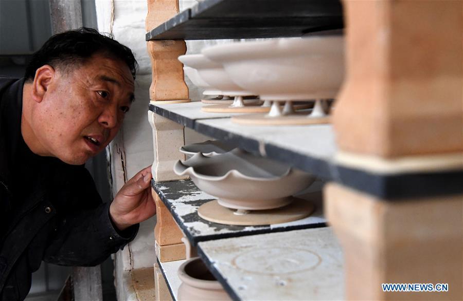 Wang Junzi checks the space of Ru porcelain kiln at his studio in Qingliangsi Village, Baofeng County of central China\'s Henan Province, May 8, 2019. Ru porcelain, one of the five famous kinds of porcelains during the Song Dynasty (960-1279) in ancient China, is known for its azure color, light body, filmy grain and gentle textile. Wang Junzi, born in 1960, is a Ru porcelain firing craftsman in Qingliangsi Village of Baofeng County in central China\'s Henan, where the ancient official Ru porcelain kiln in Song Dynasty is located. In order to reproduce the beauty of \