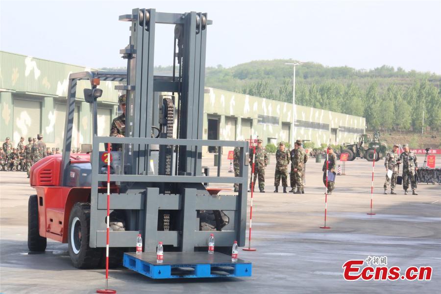 <?php echo strip_tags(addslashes(A unit of the People's Liberation Army Rocket Force held a skills contest where 100 military engineers competed to maneuver vehicles and machines including excavators, loaders, cranes, and forklifts passed various obstacles. (Photo: China News Service/Fang Lei))) ?>