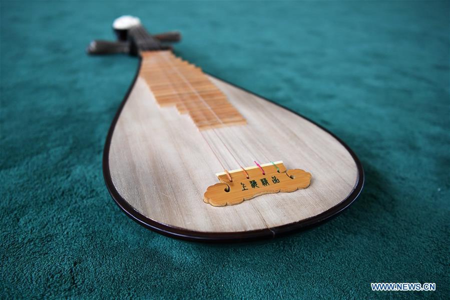 <?php echo strip_tags(addslashes(Pipa is pictured at Lanzhou traditional orchestra in Lanzhou, northwest China's Gansu Province, May 13, 2019. Pipa, a pear-shaped stringed instrument, is one of the traditional Chinese musical instruments. The pipa is played vertically and can be found in solos, ensembles or orchestras. The images of flying apsaras playing the pipa have been seen on murals in Gansu's Dunhuang Mogao Grottoes, a 1,600-year-old UNESCO world heritage site located at a cultural and religious crossroads area on the ancient Silk Road in Gansu. Nowadays contemporary dance performances inspired from those images on the murals have been staged times and times again. (Xinhua/Chen Bin))) ?>