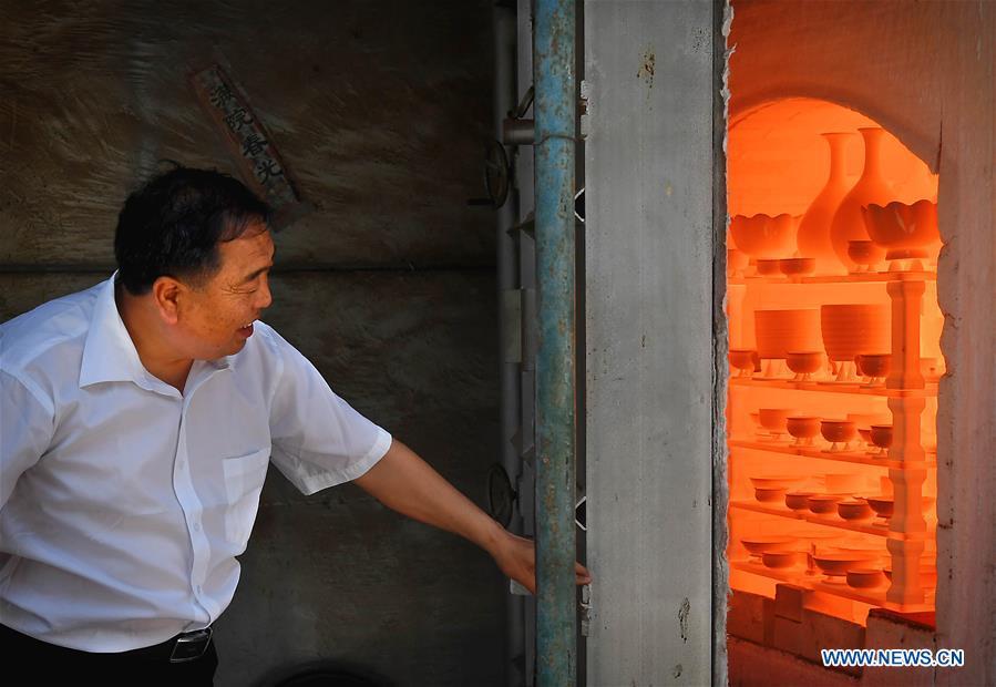 <?php echo strip_tags(addslashes(Wang Junzi opens Ru porcelain kiln at his studio in Qingliangsi Village, Baofeng County of central China's Henan Province, May 9, 2019. Ru porcelain, one of the five famous kinds of porcelains during the Song Dynasty (960-1279) in ancient China, is known for its azure color, light body, filmy grain and gentle textile. Wang Junzi, born in 1960, is a Ru porcelain firing craftsman in Qingliangsi Village of Baofeng County in central China's Henan, where the ancient official Ru porcelain kiln in Song Dynasty is located. In order to reproduce the beauty of 