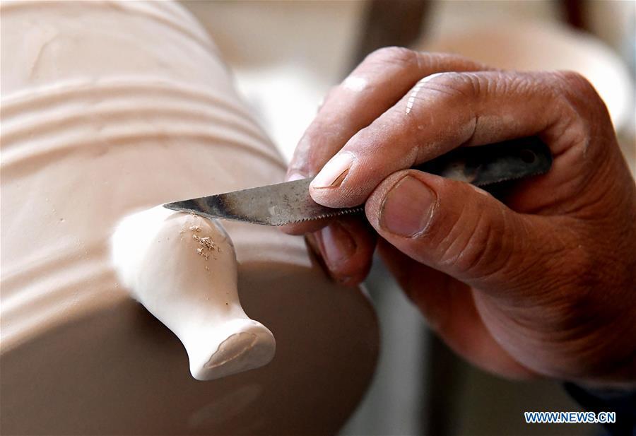 <?php echo strip_tags(addslashes(Wang Junzi makes a Ru porcelain work at his studio in Qingliangsi Village, Baofeng County of central China's Henan Province, May 8, 2019. Ru porcelain, one of the five famous kinds of porcelains during the Song Dynasty (960-1279) in ancient China, is known for its azure color, light body, filmy grain and gentle textile. Wang Junzi, born in 1960, is a Ru porcelain firing craftsman in Qingliangsi Village of Baofeng County in central China's Henan, where the ancient official Ru porcelain kiln in Song Dynasty is located. In order to reproduce the beauty of 