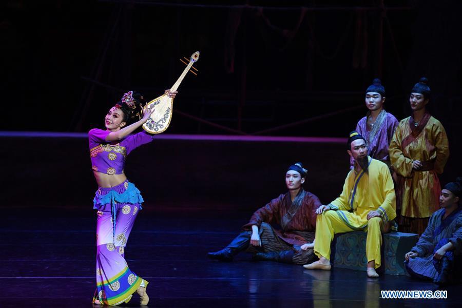 A performer holding the stage property of pipa dances during the Chinese classic dance drama \