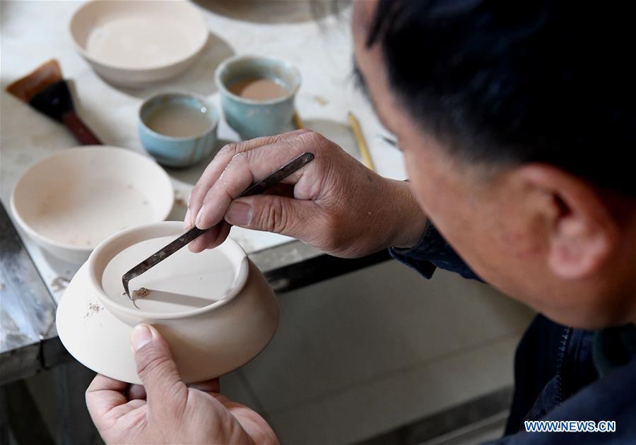 <?php echo strip_tags(addslashes(Wang Junzi makes a Ru porcelain work at his studio in Qingliangsi Village, Baofeng County of central China's Henan Province, May 8, 2019. Ru porcelain, one of the five famous kinds of porcelains during the Song Dynasty (960-1279) in ancient China, is known for its azure color, light body, filmy grain and gentle textile. Wang Junzi, born in 1960, is a Ru porcelain firing craftsman in Qingliangsi Village of Baofeng County in central China's Henan, where the ancient official Ru porcelain kiln in Song Dynasty is located. In order to reproduce the beauty of 