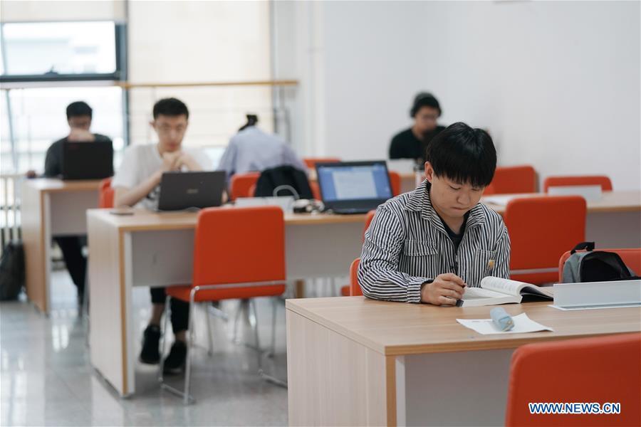 <?php echo strip_tags(addslashes(Ratjirot Aekkawat studies at a classroom of the Peking University in Beijing, capital of China, May 12, 2019. Ratjirot Aekkawat is of mixed blood from China and Thailand. He came to study in China as a junior student and now he is a postgraduate student of the Peking University. He always talks about his experience in China with relatives and friends. He has witnessed the development of China in recent years, during which the environment and local governments' working efficiencies have been greatly improved. Chinese and Thai cultures are influenced with each other. Many Thai people celebrate the Spring Festival every year and lots of Chinese go to Thailand for tourism. The photo of the historical site of Ayutthaya Dynasty taken by Ratjirot Aekkawat will be displayed in a photographic exhibition 
