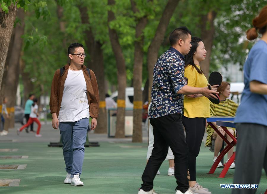 Sangay Tenzin walks on the campus of the Beijing Language and Culture University in Beijing, capital of China, May 14, 2019. Sangay Tenzin, a Bhutanese student of Beijing Language and Culture University, is one of the photographers whose work was accepted by an exhibition themed \