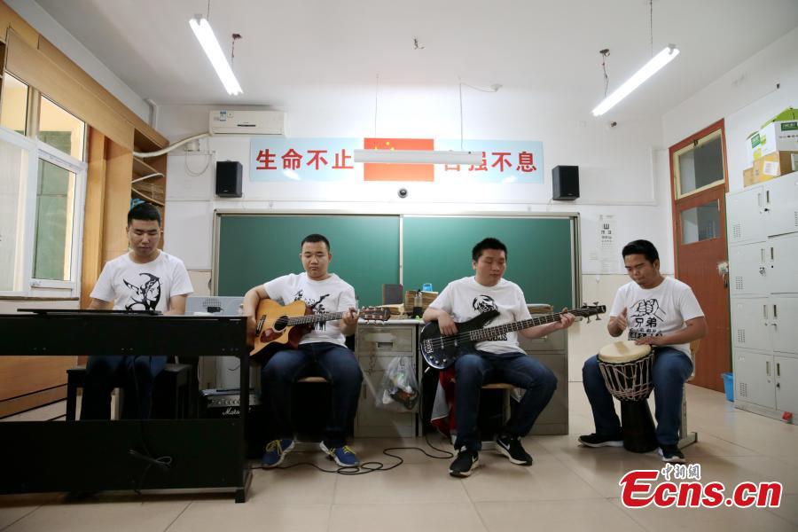<?php echo strip_tags(addslashes(A band composed of four visually-impaired students rehearse at a school in Xi’an City, Northwest China’s Shaanxi Province, May 14, 2019. The four students, all born after the year 2000, call their band Zhong Mu Tou, which literally means “heavy log’, and they mainly perform ballads and rock songs. (Photo: China News Service/Zhang Yuan))) ?>