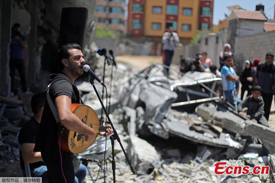 <?php echo strip_tags(addslashes(A Palestinian singer performs during a musical event calling to boycott the Eurovision Song Contest hosted by Israel, on the rubble of a building that was recently destroyed by Israeli air strikes, in Gaza City May 14, 2019.  (Photo/Agencies))) ?>