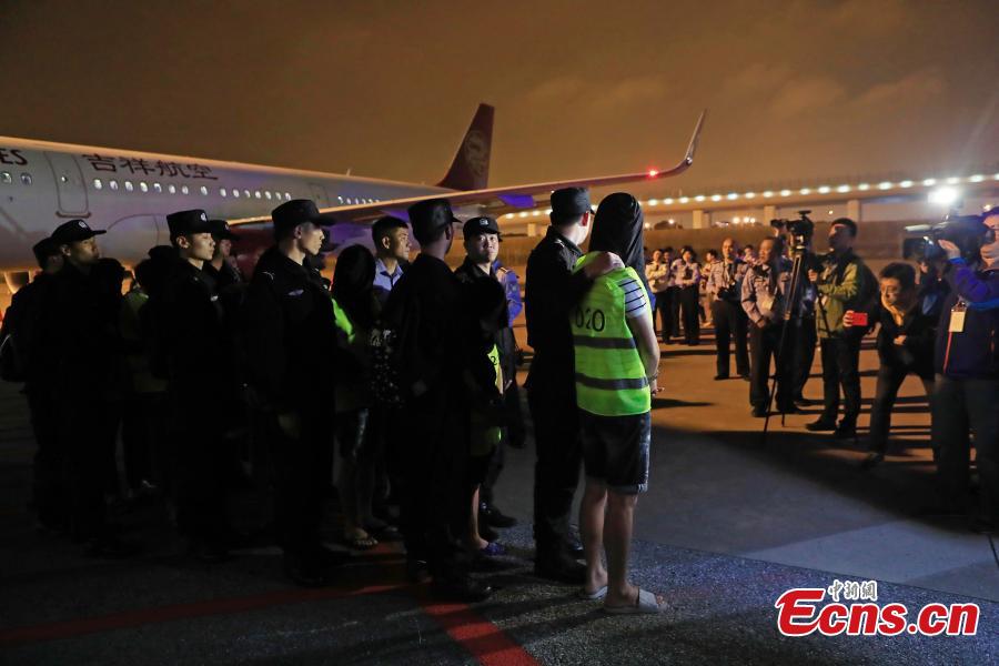 <?php echo strip_tags(addslashes(Police escort suspects caught in a social network and telecommunication fraud bust as they arrive at Pudong International Airport in Shanghai, May 14, 2019. Police detained the 57 suspects in Danzhou City of South China’s Hainan Province and then transported them to Shanghai as investigations continue.  (Photo: China News Service/Yin Liqin))) ?>
