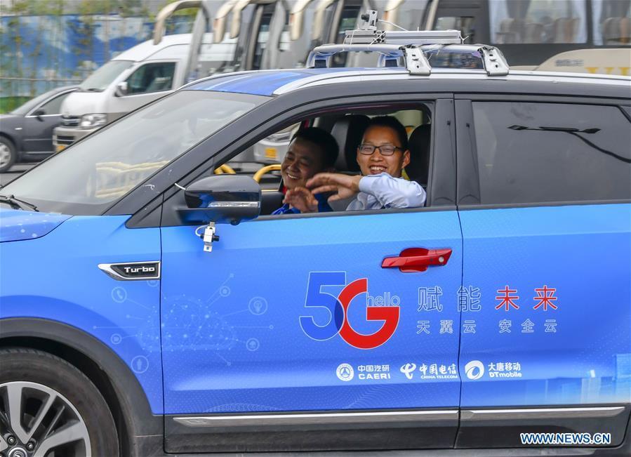 <?php echo strip_tags(addslashes(A car is controlled by a remote operator during a test run in Chongqing, southwest China, May 15, 2019. A remote-controlled car powered by the 5G network completed a test run on Wednesday in Chongqing. During the test run, a remote operator was able to control the car while watching the live feed of road conditions supported by the 5G network. (Xinhua/Liu Chan))) ?>