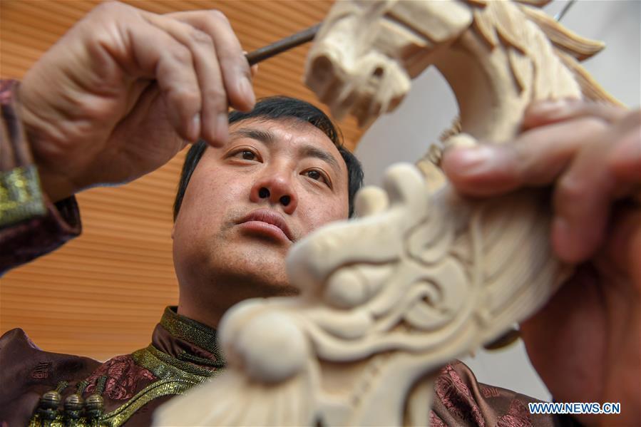 Baisu Gulang, a 37-year-old horse head fiddle maker, makes a horse head fiddle in Qian Golos Mongolian Autonomous County of Songyuan, northeast China\'s Jilin Province, May 15, 2019. Under his father\'s influence, Baisu Gulang has an ardent love in making and playing horse head fiddle, a traditional musical instrument favored by Mongolian ethnic group. He started learning to make horse head fiddle when he was 18 years old. In 2006, Baisu Gulang started a horse head fiddle making studio where he voluntarily teaches enthusiasts to make and play the instrument besides selling. (Xinhua/Zhang Nan)