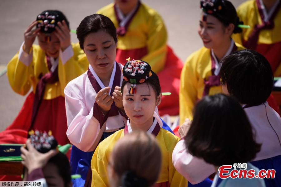 <?php echo strip_tags(addslashes(A participant recieves a traditional Korean flower cap during a traditional Coming-of-Age Day ceremony to mark adulthood at Namsan hanok village in Seoul on May 20, 2019.  The ceremony marks the age of 19, at which a person is legally able to make life choices from voting, to drinking alcohol.(Photo/Agencies))) ?>