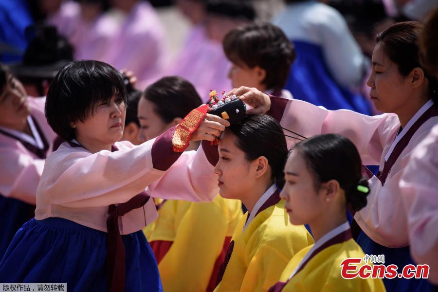 <?php echo strip_tags(addslashes(A participant recieves a traditional Korean flower cap during a traditional Coming-of-Age Day ceremony to mark adulthood at Namsan hanok village in Seoul on May 20, 2019. The ceremony marks the age of 19, at which a person is legally able to make life choices from voting, to drinking alcohol.(Photo/Agencies))) ?>