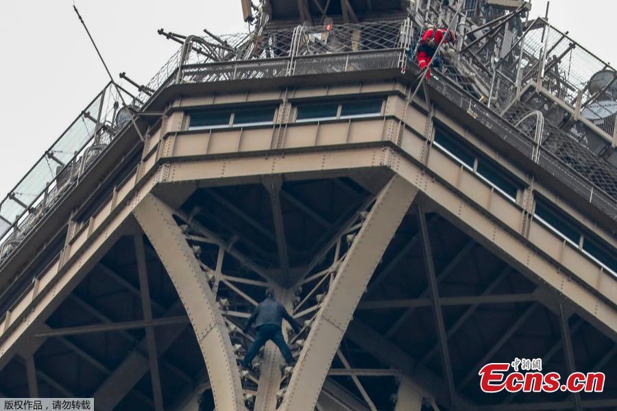 <?php echo strip_tags(addslashes(A man (C) climbs up to the top of the Eiffel Tower, in Paris, without any protection as a firefighter (R) looks down at him from the top, on May 20, 2019. The Eiffel Tower was evacuated on May 20, 2019 in the afternoon after a person was spotted climbing up the Paris landmark, the company that operates the structure said. 