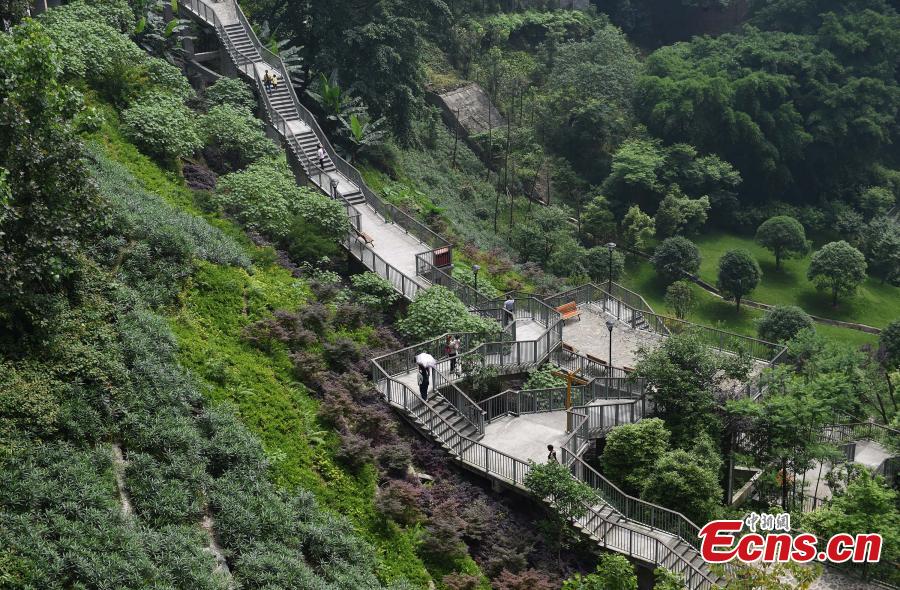 A view of a pathway built along a hilly slope leading to the entrance of a residential community in Yuzhong District, Southwest China’s Chongqing Municipality, May 22, 2019. The road is about one kilometre long, with a height of nearly 100 meters. Built on mountains, the city has been nicknamed a \