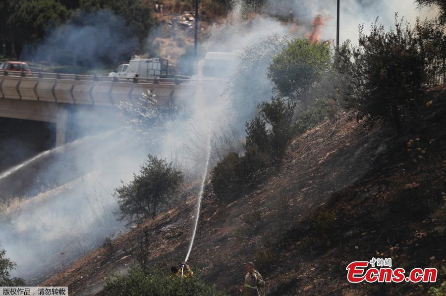 Firefighters extinguish a fire in a forest amidst extreme heat wave near the Israeli city of Modiin on May 23, 2019.  (Photo/Agencies)