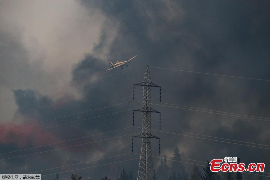 <?php echo strip_tags(addslashes(A picture taken on May 23, 2019 shows a helicopter flying over a burning forest amidst extreme heat wave near the Israeli city of Modiin on May 23, 2019. (Photo/Agencies))) ?>